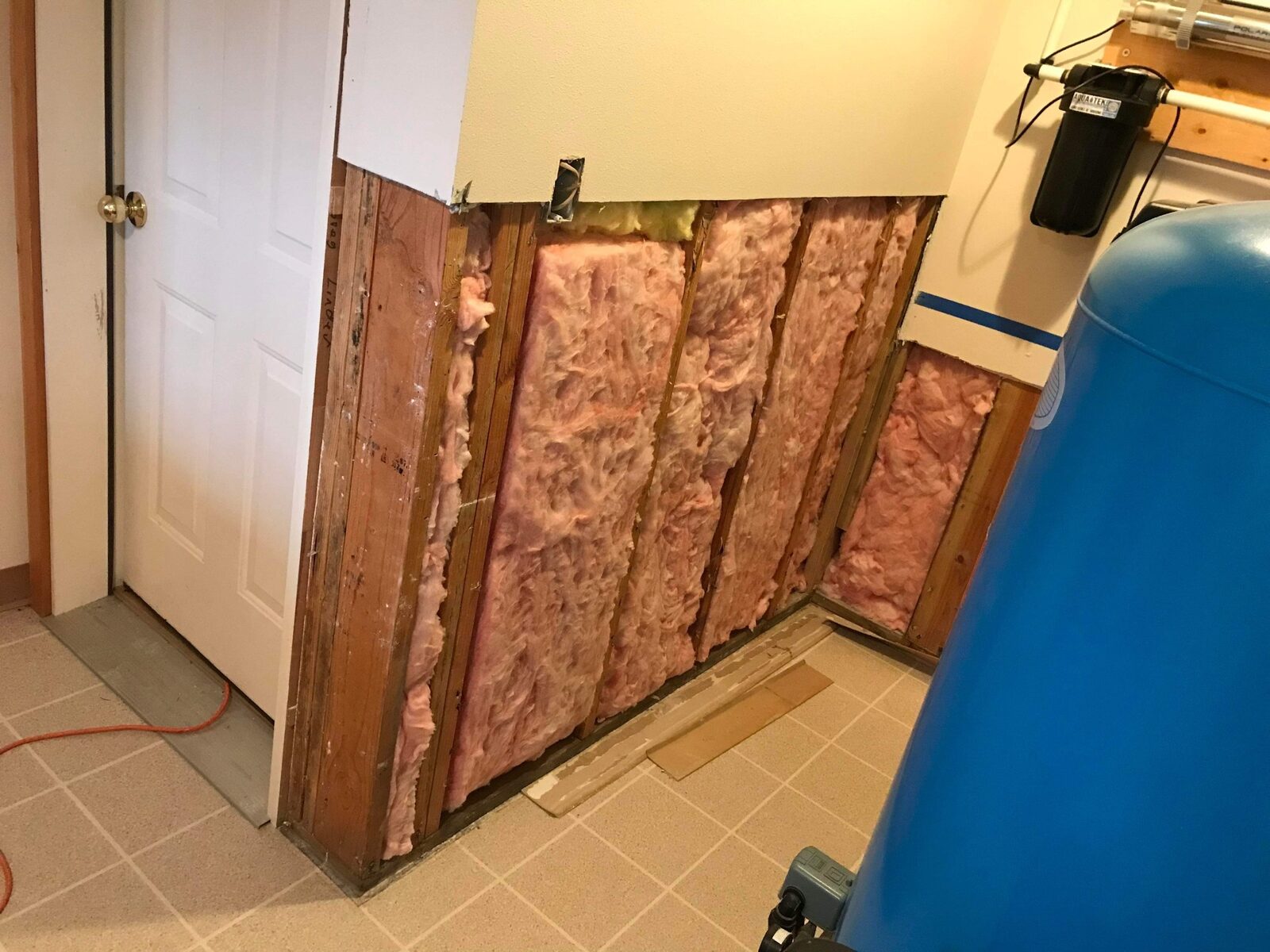 Utility room wall opened to the studs before repair